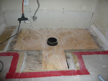 Toilet Flange: Water damage, mold contaminated plywood substrate removal